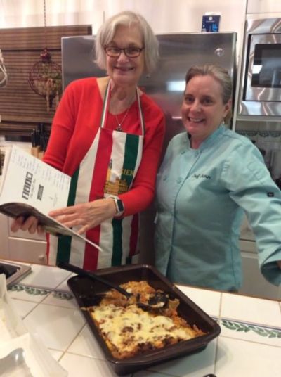 Kathy Nano Bolanowski with Chef Jen holding Italian cookbook.