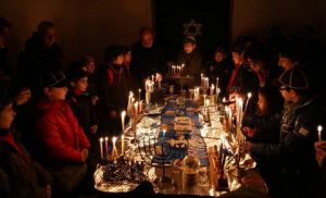 Don Gigi Iuliano and Rabbi Barbara Aiello conduct an interfaith Chanukah service in Serrastretta, Italy, the first active synagogue in Calabria since Inquisition times. photo credit Domenico Pulice