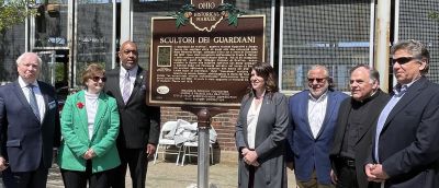 Flanking the new Ohio Historical Marker on Random Road in Little Italy are, from left: Tom Chema, Mary Fatica-Martin, Council President Blaine Griffin, Pamela Dorazio-Dean, Joe Marinucci, Father Joe Previte and Anthony Pinto.