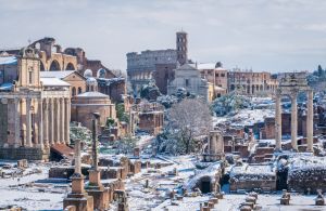 Snow in Rome in February 2018, the Roman Forum with the Colosseum in the background as seen from Campidoglio, Rome, Italy.